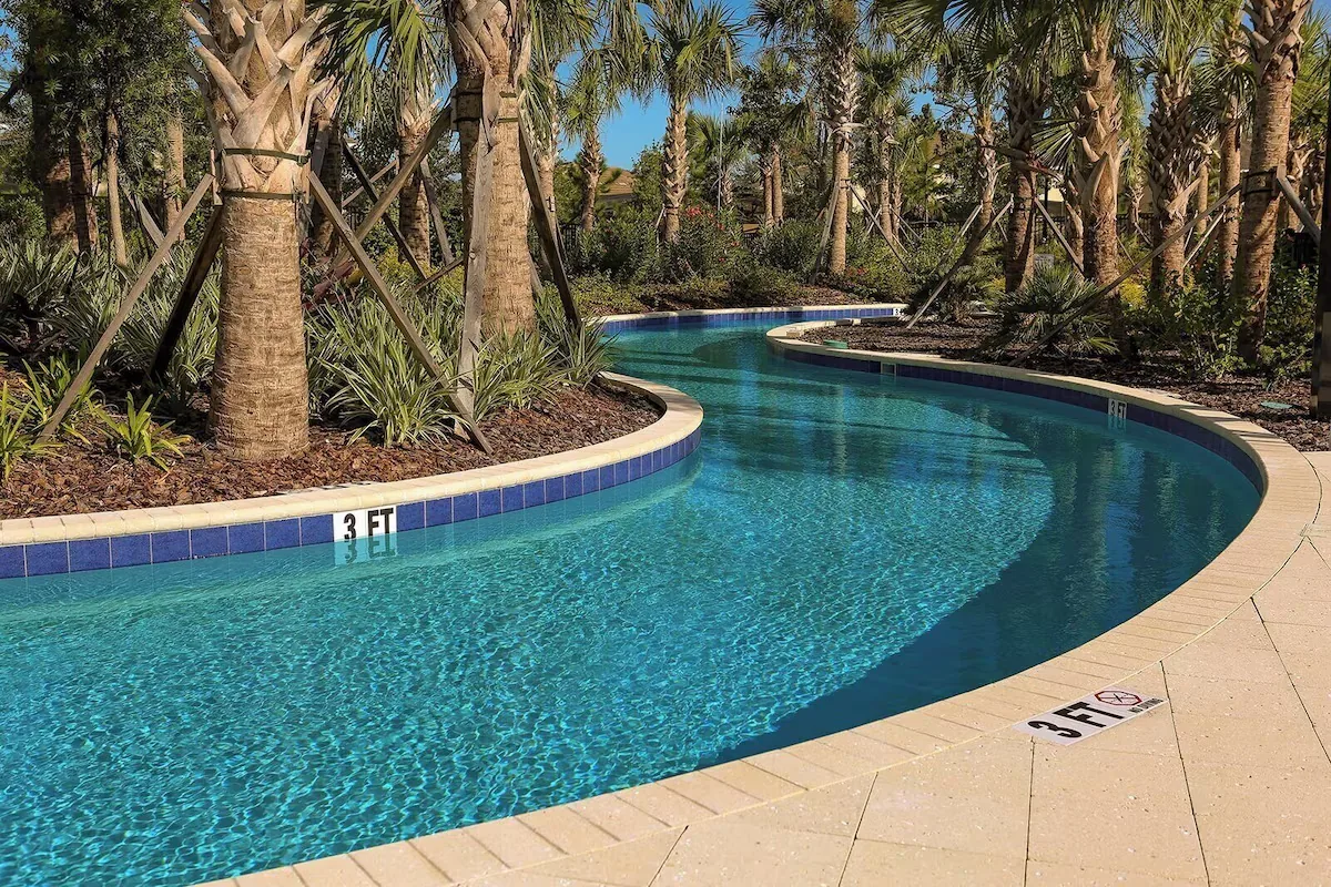 Lazy river winding through palm trees at Solterra Resort